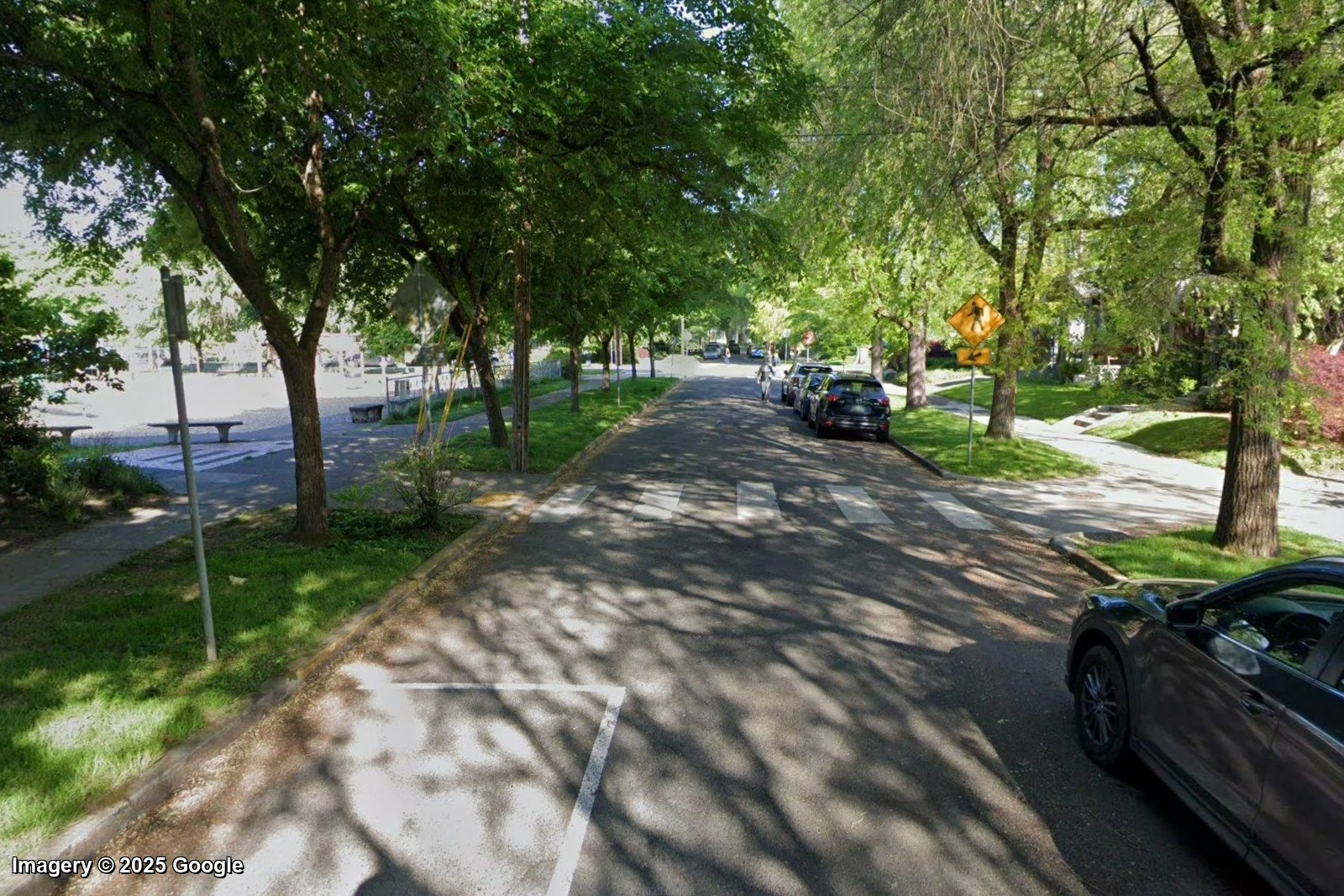 A tree-shaded residential street in Ladd's Addition, Portland, with sidewalks and a small park, the kind of street Walk Grade rates an A