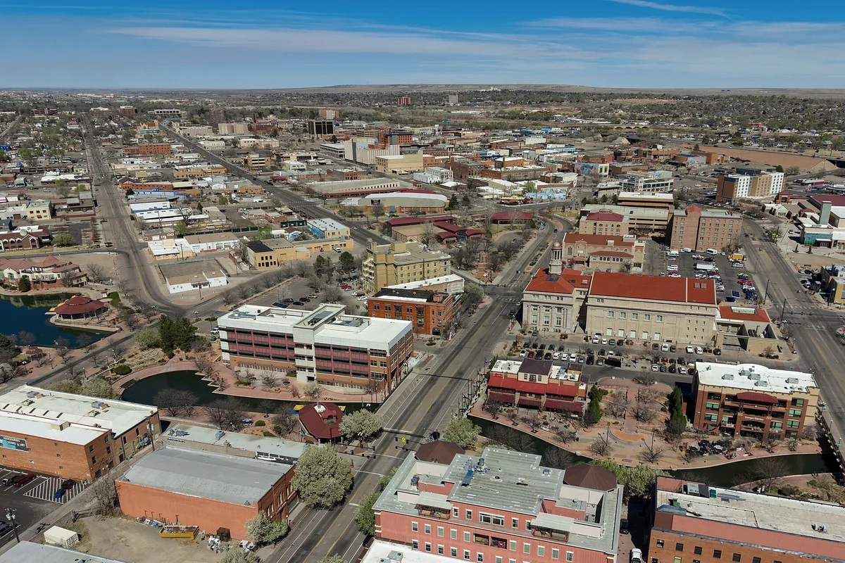 Aerial view of downtown Pueblo, Colorado (pop. 111,876), featuring the historic Arkansas Riverwalk